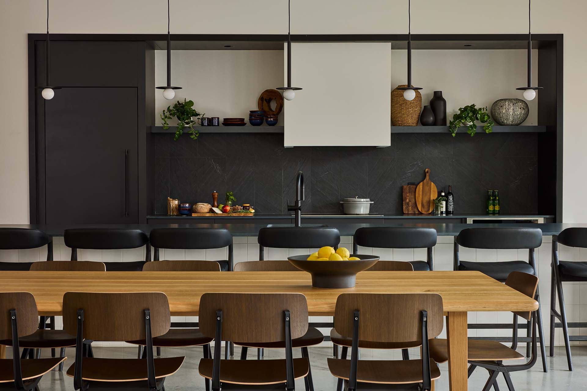 Jessup House community lounge with dining table and community kitchen.