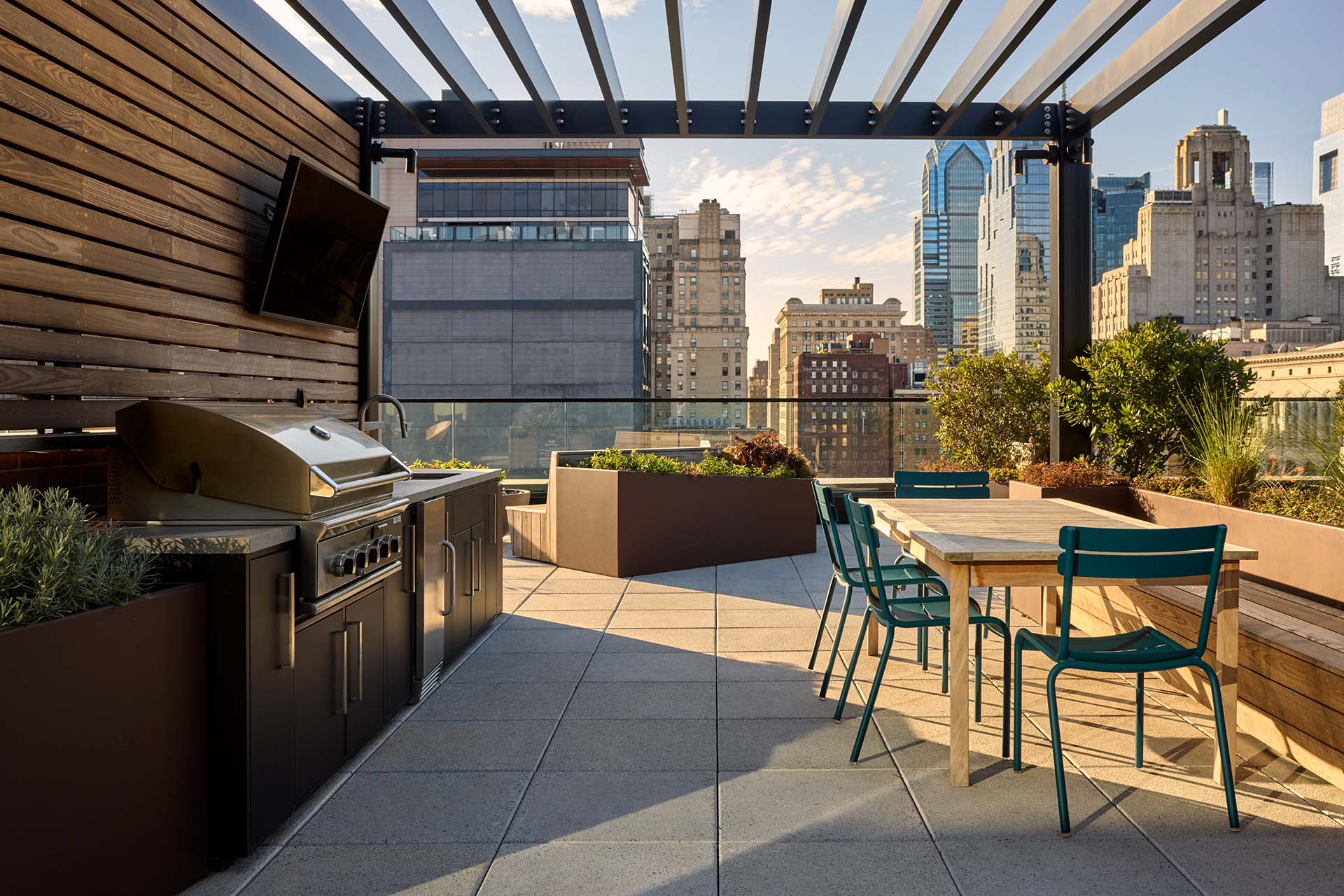 Jessup House community skydeck lounge with built in BBQ grill and dining tables.